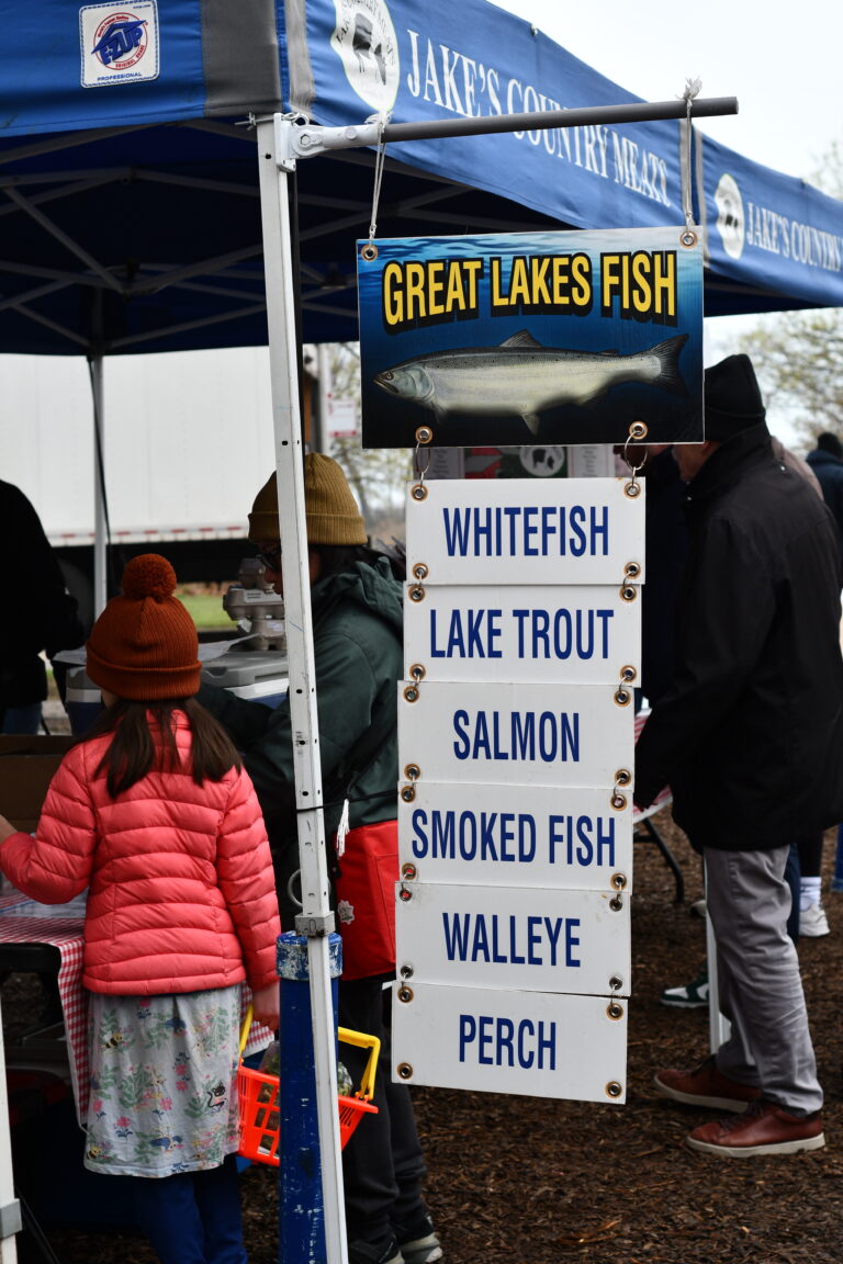 Photo of market signage listing great lakes fish available from Massey Fish Company at Jake's Country Meats Green City Market stand.
